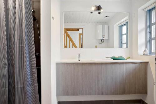 a bathroom with a sink and a mirror at 0213-Romo-A-Hveyselsvej-3 in Høm