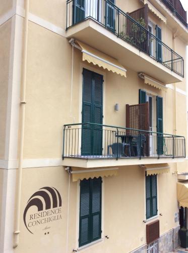 ein Gebäude mit einem Balkon und einem Schild darauf in der Unterkunft Residence Conchiglia Aparthotel in Alassio