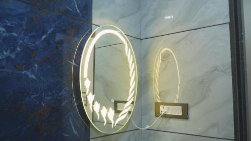 a round mirror on a wall in a room at Shaahi Resort Harda in Bhunās