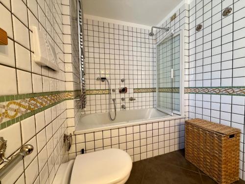 a bathroom with a toilet and a bath tub at Borealis - VOTRE MAISON in Cogne