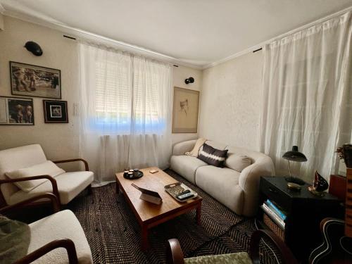 a living room with a couch and a coffee table at Maison familiale in Paulhac