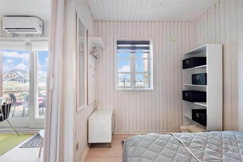 a bedroom with a bed and a window at 0430-Romo-Vestergade-3-Ap-71 in Høm