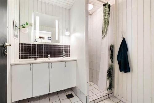 a white bathroom with a sink and a mirror at 0430-Romo-Vestergade-3-Ap-71 in Høm
