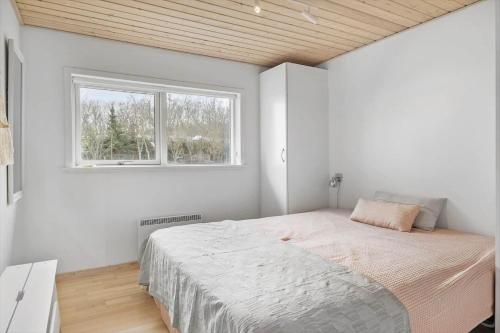 a bedroom with a large bed and a window at HA317-Hals-Bisnapkrat-10 in Hals