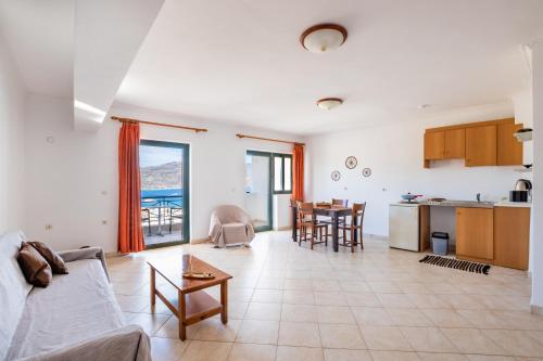 a living room with a couch and a table at Fronis Studios in Karpathos