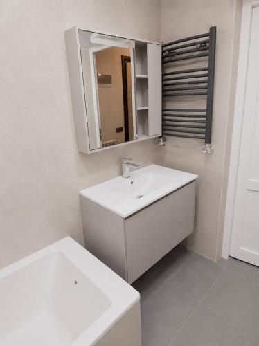a bathroom with a white sink and a mirror at White Residency in Yerevan