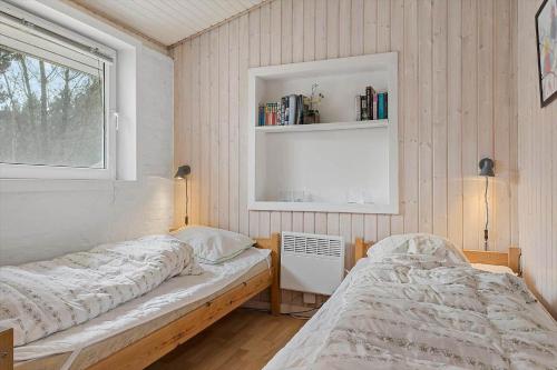 a bedroom with two beds and a window at 0416-Romo-Dyssebjergvej-13 in Høm
