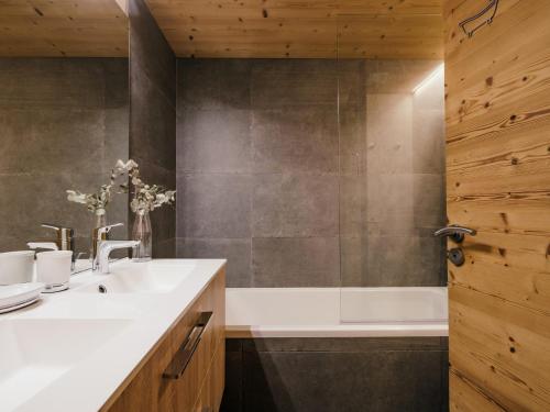 a bathroom with a sink and a bath tub at Chalet 4★, 15 pers, La Clusaz, sauna, centre village, 7 chambres - FR-1-304-177 in La Clusaz