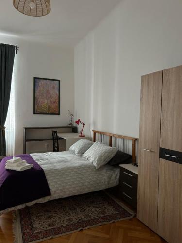 a bedroom with a bed and a dresser in it at Ultra Central Cluj-Napoca in Cluj-Napoca