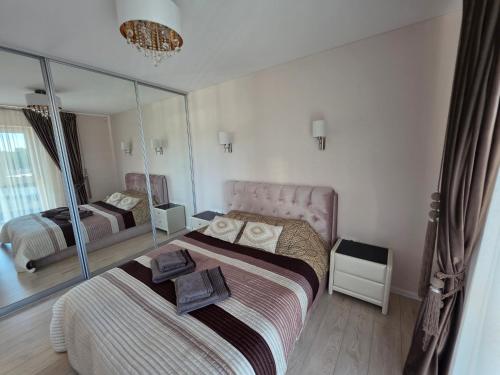 a bedroom with two beds and a mirror at Nemunas Riverside in Kaunas
