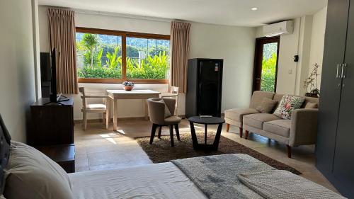 a living room with a bed and a dining room at Villa Lombok Surga Kedua Setangi in Mangsit