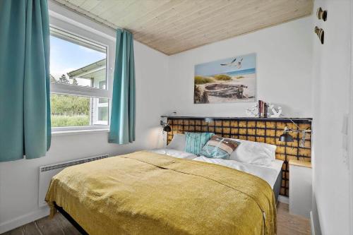 a bedroom with a bed and a window at 0498-Romo-Godthabsvej-29 in Høm