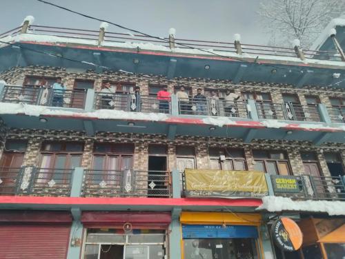 people on the balconies of an apartment building at Rock View in Kulu