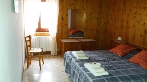 a bedroom with a bed with towels on it at La Borgata in Boiano