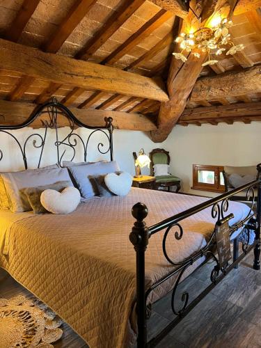 a bedroom with a large bed with a wooden ceiling at B&B Il Castello di Alberico in Cotignola