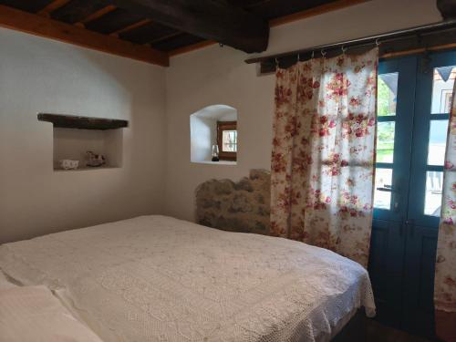 a bedroom with a bed and a window at Štalca in Bušinja Vas