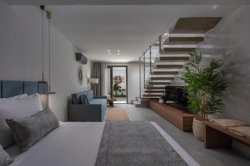 a living room with a bed and a staircase at Kassandra Villas in Hanioti