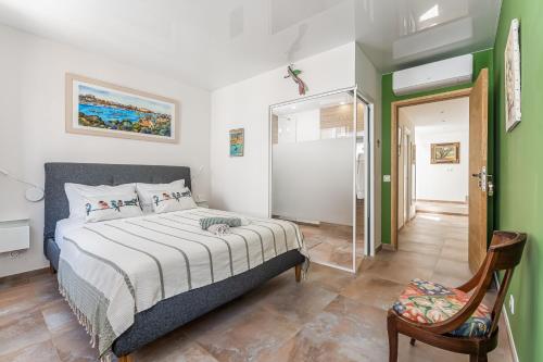 a bedroom with a bed and a chair at Casa S’Arraval in Mahón