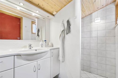 a white bathroom with a sink and a shower at 13318-Asnaes-Lindevej-10 in Asnæs