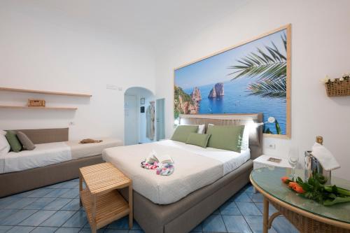 a room with two beds and a table in it at Sharon House in Amalfi