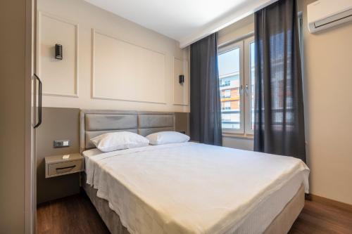 a bedroom with a large bed and a window at Premium Rezidans Otel in Antalya