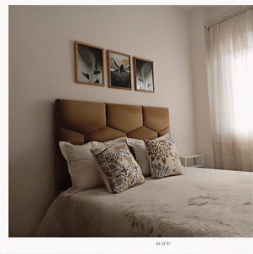 a bedroom with a bed with three pictures on the wall at Royal Welcome Casanearshore B&B in Casablanca
