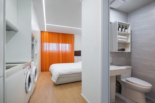 a bathroom with a bed and a toilet and a sink at 스태이링크 Staylink in Seoul