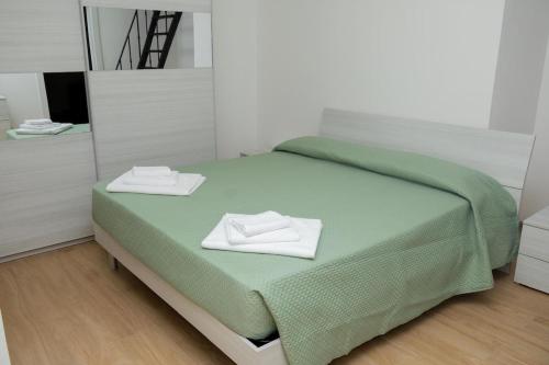 a bedroom with a bed with two towels on it at Apollinare's House in Classe