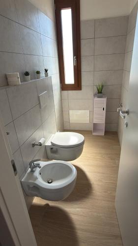 a bathroom with a toilet and a bidet at Apollinare's House in Classe