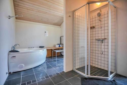 a large bathroom with a tub and a shower at 11806-Nykobing-Sj-Klintegarden-1 in Klint