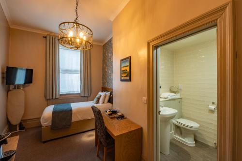 a hotel room with a bed and a bathroom at The Goddard Arms in Swindon