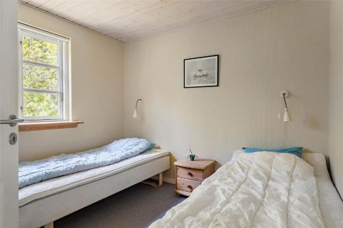a bedroom with two beds and a window at LF584-Hurup-Thy-Haettemagevej-4 in Sindrup