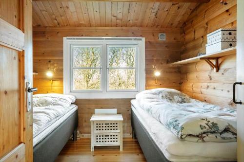 two beds in a room with a window at LF609-Hurup-Thy-Bakkesiden-9 in Doverodde