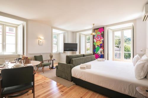 a bedroom with a bed and a living room at Pendoa Sintra Collection-Soft Opening in Sintra