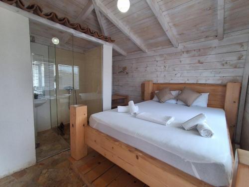 a bedroom with a large white bed in a room at White house in Donji Štoj