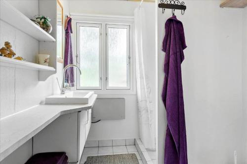 a white bathroom with a sink and a shower at LF14218-Roslev-Skovsovej-4 in Roslev