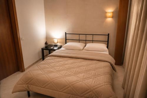 a bedroom with a bed with two pillows on it at Siena in Preveza