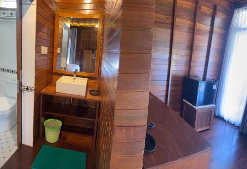 a bathroom with a sink and a mirror at Bukit Kembang Sari in Bugbug