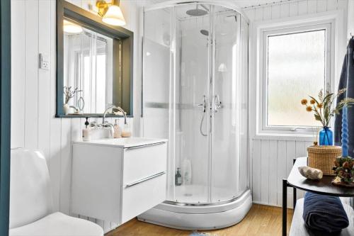 a white bathroom with a shower and a sink at LF15233-Hojslev-Jelsevej-261 in Højslev