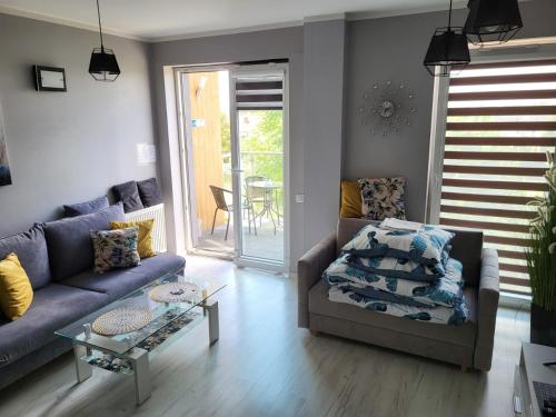 a living room with a couch and a table at Apartament DeLuxe 4 in Oświęcim