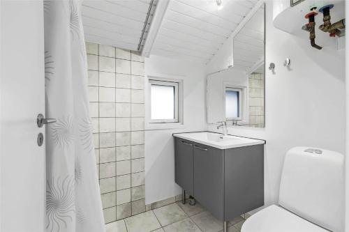 a white bathroom with a sink and a toilet at 13338-Asnaes-Hogevej-22 in Asnæs