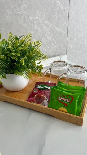 a wooden tray with snacks and a plant on it at Studio in Darhan