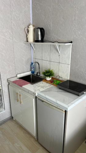 a small kitchen with a sink and a counter at Studio in Darhan
