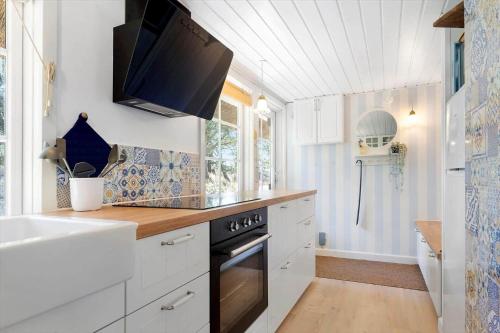 a kitchen with a sink and a stove at 0025-Romo-P-J-Manosvej-18 in Høm