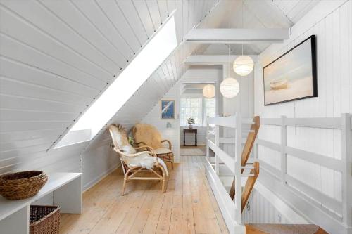 a staircase in a house with white walls and chairs at 0025-Romo-P-J-Manosvej-18 in Høm