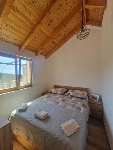 a bedroom with a bed and a large window at Robinson Hideaway Korčula in Korčula