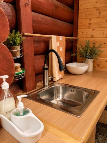 a kitchen sink with a soap dispenser on a counter at Peaceful Nature Cottage near Talsi with Hot Tub, Sauna & Pond, Camping Ives in Talsi