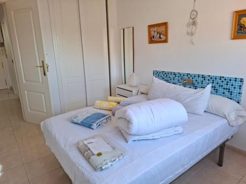 a white bed with pillows on it in a room at Apartamento Playasol in Vícar