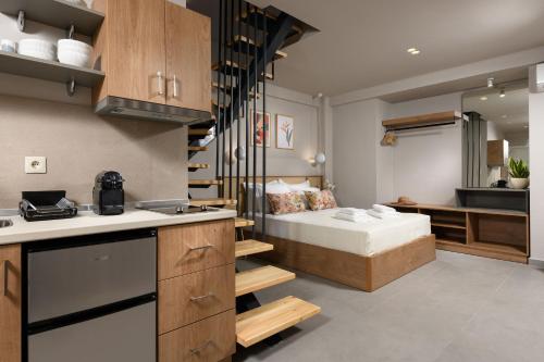 a kitchen and a bedroom with a bed in a room at Aeliana Thassos Studios & Lofts in Skala Rachoniou