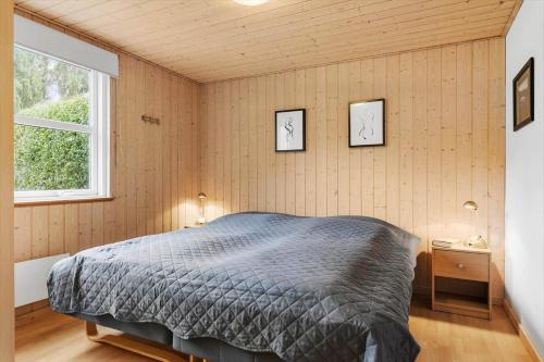a bedroom with a bed and two pictures on the wall at LF15149-Farso-Ramshule-49 in Farsø